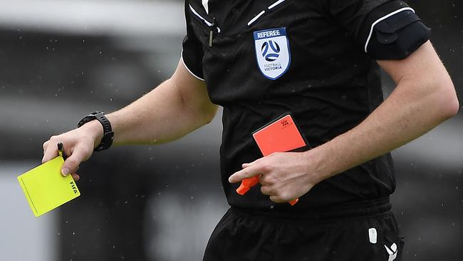 NPL VIC Men, Round 2, Avondale FC vs Port Melbourne Sharks SC, played at Avenger Park, Parkville, Victoria, Saturday 15th February 2025. Match referee holding a yellow card. Picture: Andrew Batsch