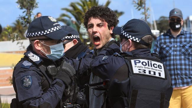 Police arrest a protester at St Kilda. Picture: William West