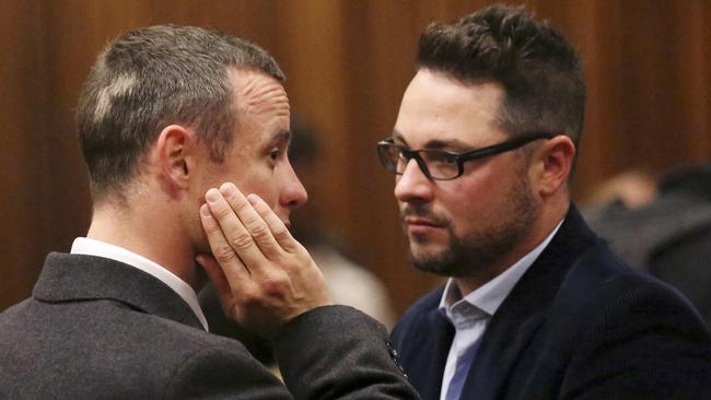 In rehab ... Oscar Pistorius speaks with his brother Carl Pistorius, who may miss the verdict. Picture: AP