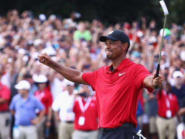 Tiger Woods of the United States celebrates making a par on the 18th green