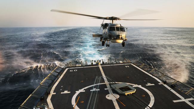 HMAS Melbourne's embarked Seahawk helicopter prepares to land.