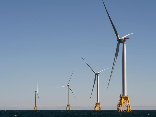 Wind turbines, of the Block Island Wind Farm, tower above the water on October 14, 2016 off the shores of Block Island, Rhode Island. The first offshore wind project in the US has created more than 300 construction jobs and will deliver the electricity demands for the entire island.  / AFP PHOTO / DON EMMERT