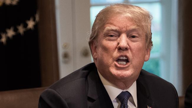 (FILES) In this file photo taken on April 9, 2018 US President Donald Trump speaks during a meeting with senior military leaders at the White House in Washington, DC. US President Donald Trump said April 11, 2018 that "missiles will be coming" in response to an alleged chemical attack in Syria, defying Russian warnings against a strike. Upping the stakes in an escalating confrontation with Moscow, Trump took to Twitter in the strongest assertion yet that he plans to take military action in Syria.   / AFP PHOTO / NICHOLAS KAMM