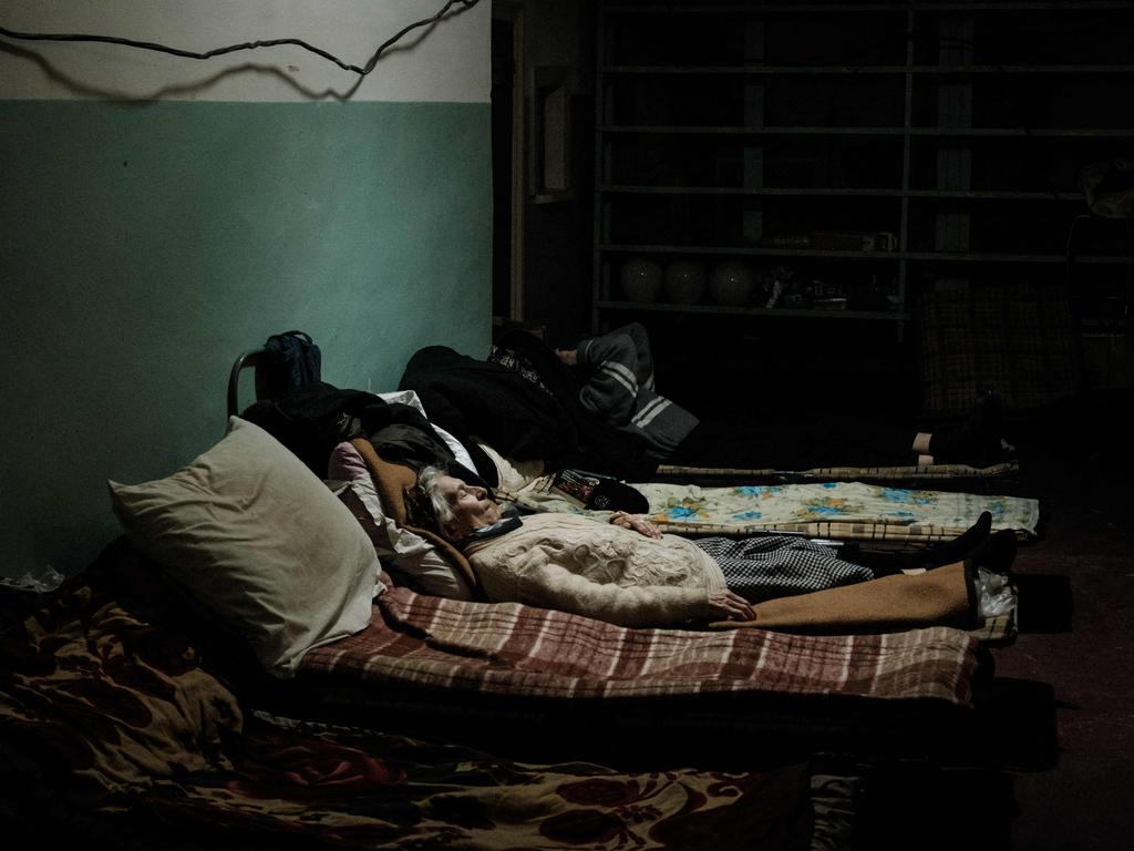 An 85-year-old woman sleeps on her bed in the bunker of Ostchem factory in Severodonetsk, eastern Ukraine, amid the Russian invasion of Ukraine. Picture: AFP