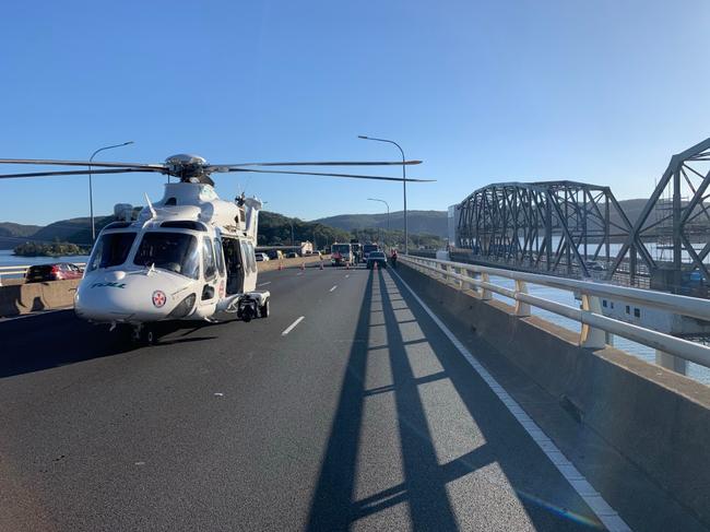 A Toll rescue helicopter has landed at the scene to assist transporting the injured driver. Picture: Live Traffic NSW
