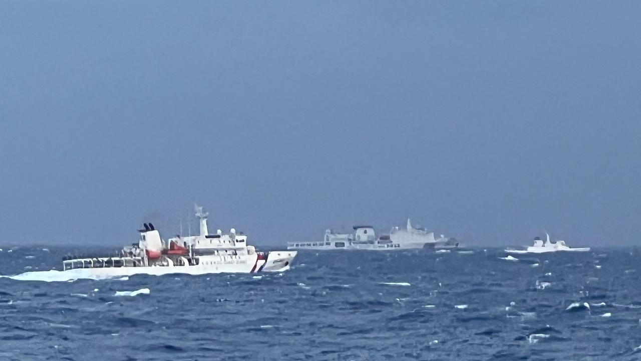 This handout photograph taken between December 7-8, 2024 and released on December 9 by the Taiwan Coast Guard shows a Chinese coast guard ship (C) seen past Taiwan Coast Guard vessels (L and R) in waters east of Taiwan. (Photo by Handout / TAIWAN COAST GUARD / AFP)