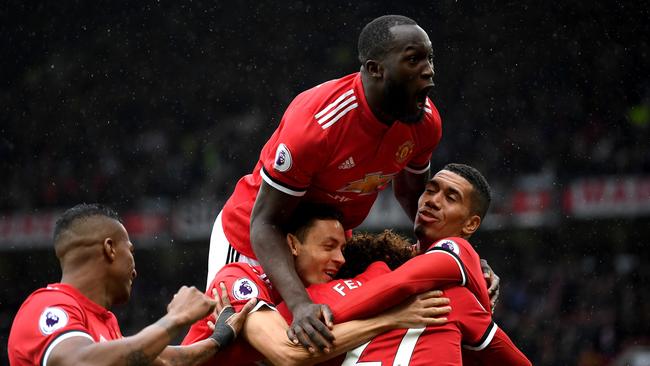 Romelu Lukaku (top) celebrates with Manchester United players.