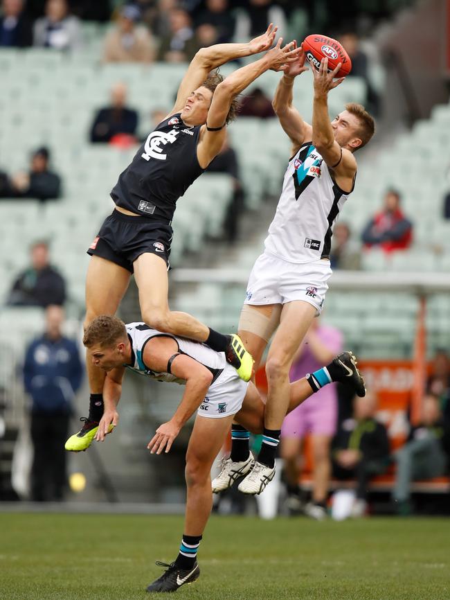 Port Adelaide’s Dan Houston takes a grab over Carlton’s Charlie Curnow. Picture: Michael Willson/AFL Media/Getty Images