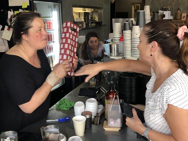 Loyal customer Fay Hadley hands over a thank you gift to Maria Panagiotopoulos. Picture: Jim O'Rourke