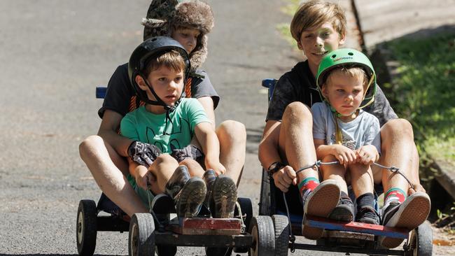 Yared and Fraser Pritchard take William and James Smith down the hill in the Woombye Australia Day Billy Cart Challenge on Queensland’s Sunshine Coast. Picture Lachie Millard