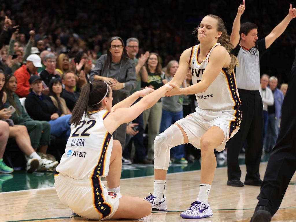 Wallace helping her teammate Clark up off the floor and when the Australian is not on the floor she is awe of the talent. Picture: Scott Eklund/NBAE via Getty Images