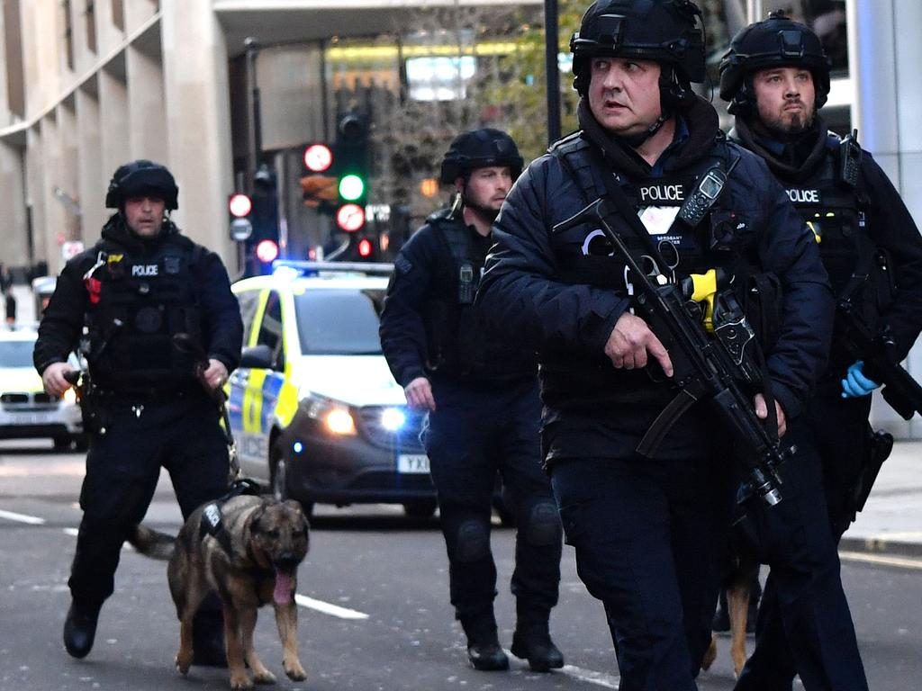 Armed police with dogs patrol checked the area for explosives. Picture: Ben STANSALL / AFP