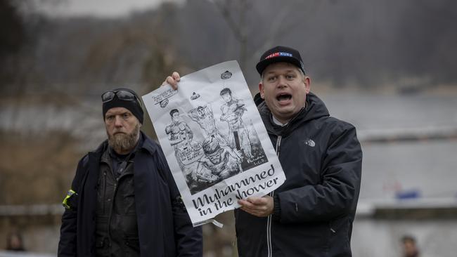 Right-wing Swedish-Danish politician Rasmus Paludan holds a caricature drawing depicting the prophet Muhammed naked in a shower outside the Turkish embassy in Stockholm.