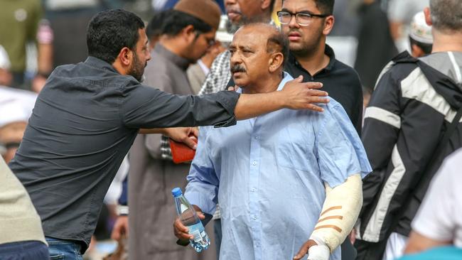 An injured man at a prayer service at Hagley Park, opposite the Al Noor Mosque, in Christchurch yesterday. Picture: AAP 