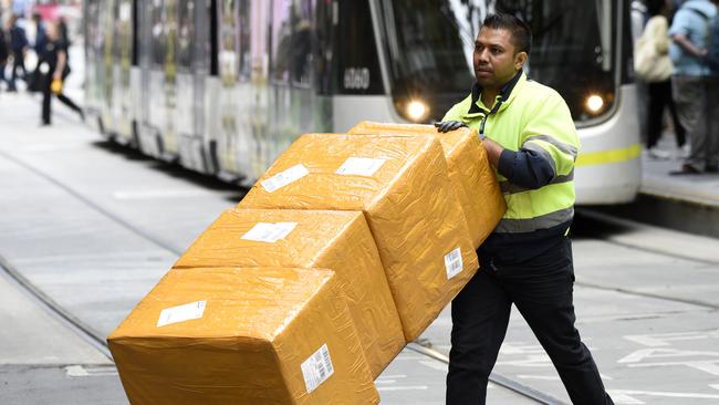 MELBOURNE, AUSTRALIA - NewsWire Photos DECEMBER 15, 2022: ABS generics - A delivery driver with boxes in the Bourke Street Mall in central Melbourne. Picture: NCA NewsWire / Andrew Henshaw