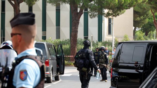 Law enforcement officers stand nearby a synagogue following the fire and explosion of cars in La Grande-Motte, south of France. Picture: AFP