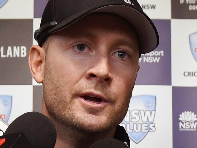 Australian cricket captain Michael Clarke is watched by young players at his cricket academy as he gives a press conference in Sydney on September 25, 2014. Clarke is battling a hamstring injury which threatens his involvement in the two Tests against Pakistan starting late next month, however the skipper is confident he's on track to a full recovery. AFP PHOTO/William WEST