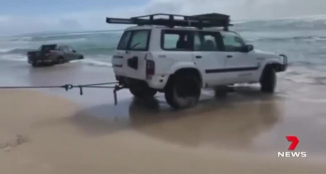 WATCH VIDEO 1: 4WD pulled from the ocean at Teewah Beach. Credit: 7 News