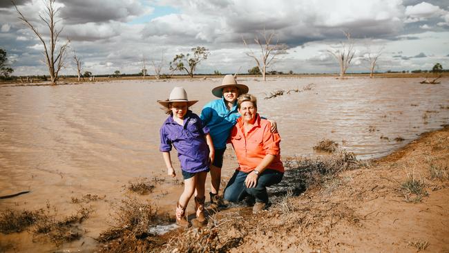 Janie Tink with her children Nelly, 7, left, and Darcy, 9, at their rain-drenched property near Narromine, in central NSW. Picture: Clancy Paine