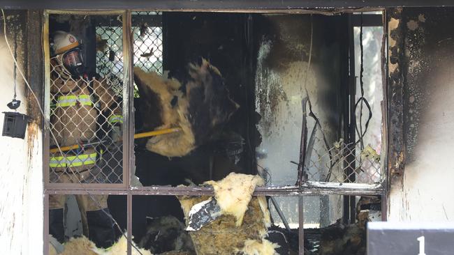 Firefighters sifting through the wreckage of the Ashmore home. Picture: Glenn Hampson