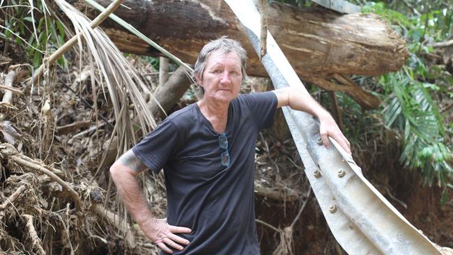 Cape Tribulation resident Stephen Maloney, standing amidst the wreckage near Rykers Creek, is frustrated with the lack of assistance provided following ex-Tropical Cyclone Jasper.