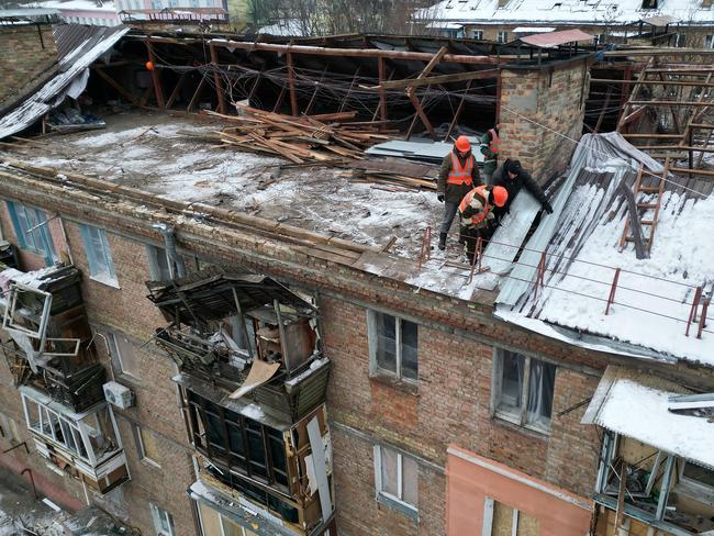 Workmen on a roof damaged by a missile attack in Vyshhorod, Ukraine. Picture: Getty Images