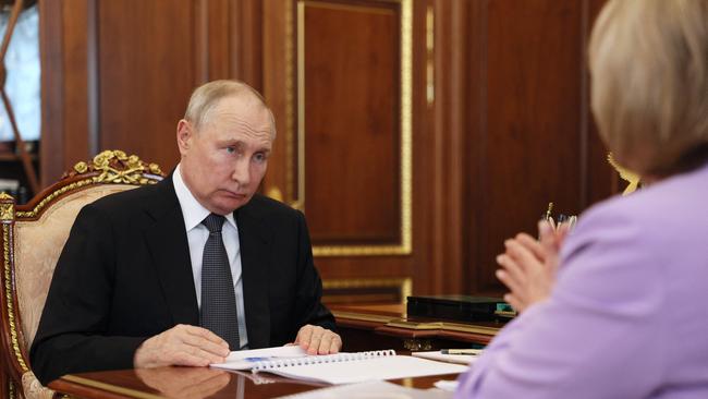 Russian President Vladimir Putin meets with the country's Central Election Commission head Ella Pamfilova at the Kremlin. The ICC is probing war crimes against him. Picture: AFP