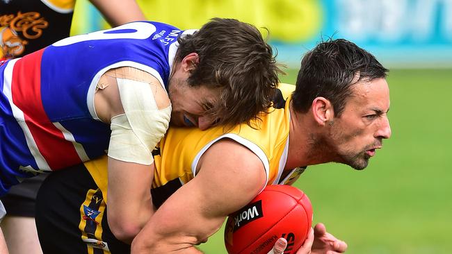 Pictured is the Peninsula Football Netball League qualifying final of Australian Rules Football between Frankston YCW (yellow and black with black shorts) versus Mornington (red, white, blue with white shorts) at Frankston Park in Frankston. Joel Miller tackles Tony Lester. Picture: Derrick den Hollander