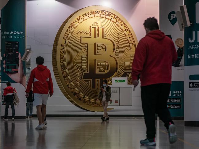 Australia has an opportunity to become a true blockchain and cryptocurrency hub globally, says government senator Andrew Bragg. Above, a Bitcoin poster in Hong Kong. Picture: Getty Images