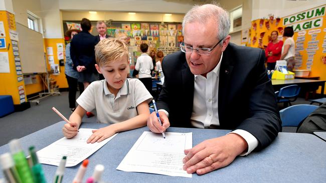 Scott Morrison and a student at Galilee Catholic Primary School in Sydney. Picture: AAP