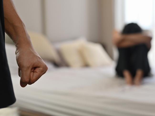 istock generic:  woman, abuse, DV, domestic violence, harassment, sexual harassment.   Selective focus on the fist male with crying man sits on a bed as the background, Violence, Love and relationships, Gay couple, sexual harassment concept. . Picture: istock