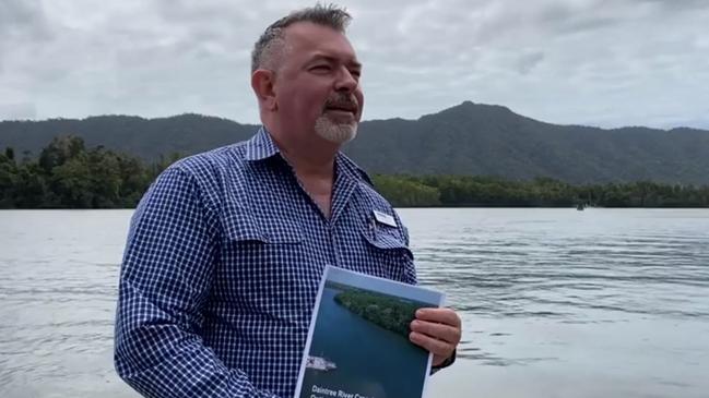 Douglas Shire Mayor Michael Kerr holds a Daintree River crossing options report last year at the Daintree River.