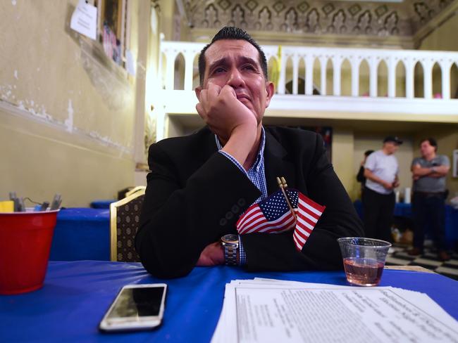 TOPSHOT - An emotional Gerardo Ruiz watches the Election results from the headquarters of US Democratic presidential Hillary Clinton in East Los Angeles on November 8, 2016. / AFP PHOTO / Frederic J. BROWN
