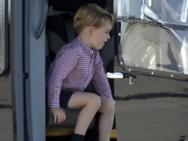 Prince George looks happy as he gets to grips with the helicopter. Picture: Christina Sabrowsky/AP