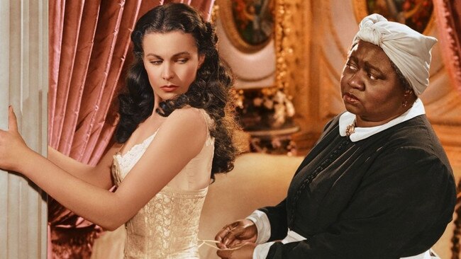 Scarlett (Vivien Leigh) being laced into a corset by Mammy (Hattie McDaniel) in Gone With the Wind.