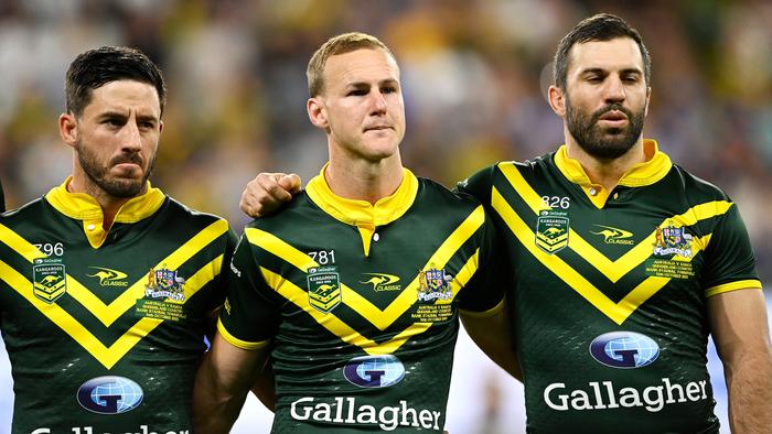 TOWNSVILLE, AUSTRALIA - OCTOBER 14: Ben Hunt, Daly Cherry-Evans and James Tedesco of the Kangaroos stand for the national anthem before the Mens Pacific Championship match between Australia Kangaroos and Samoa at Queensland Country Bank Stadium on October 14, 2023 in Townsville, Australia. (Photo by Ian Hitchcock/Getty Images)