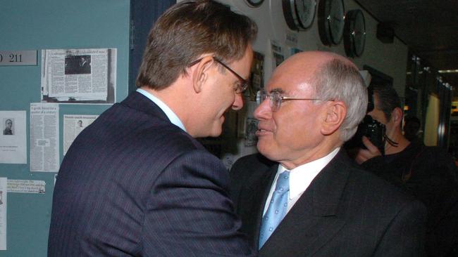 The famously aggressive handshake from then Labor leader Mark Latham, left, when he met John Howard at the ABC Radio studios in Sydney during the 2004 election campaign. Picture: John Feder