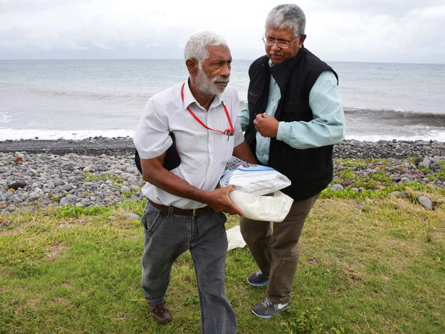 A team of multi national task force investigators search Saint-Andre beach on Reunion Island looking for possible debris. Picture: Cameron Richardson