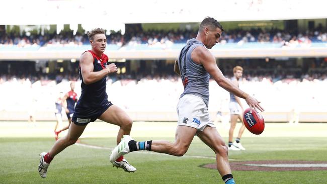 Tom Rockliff gets his kick away against Melbourne in Round 1. Picture: Daniel Pockett/AAP