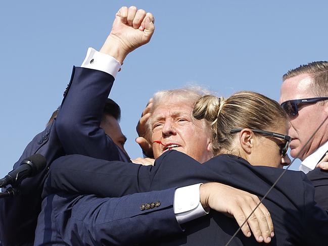 BUTLER, PENNSYLVANIA - JULY 13: Republican presidential candidate former President Donald Trump is rushed offstage by U.S. Secret Service agents after being grazed by a bullet during a rally on July 13, 2024 in Butler, Pennsylvania.   Anna Moneymaker/Getty Images/AFP (Photo by Anna Moneymaker / GETTY IMAGES NORTH AMERICA / Getty Images via AFP)