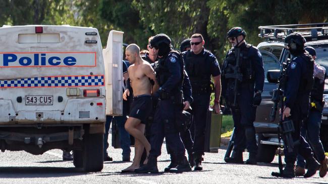 Police take a man into custody after a siege in Doonkuna St, Kingaroy. March 21, 2022. Picture: Dominic Elsome