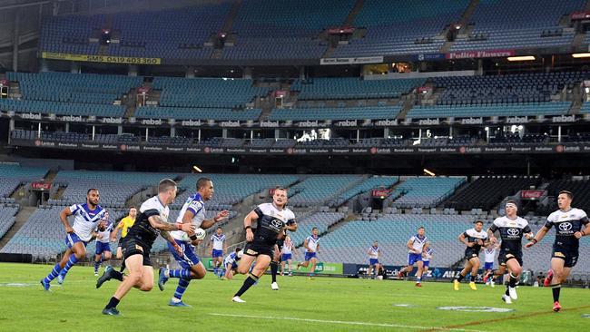 The match being played at a near-empty stadium.