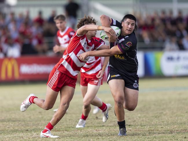 Marsden SHSÃ¢â¬â¢s Jury Taewa (18) breaks a tackle from Palm Beach Currumbin State HighÃ¢â¬â¢s Jac Finigan (12)