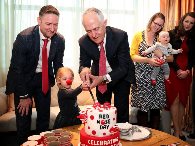 When the PM steps in to help you cut a cake, it must be Red Nose Day. Picture: Kym Smith