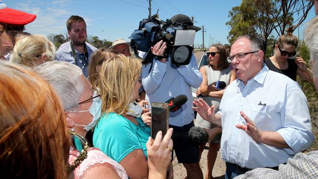 Environment Minister Ian Hunter talks to angry Port Augusta residents after his visit to the Northern Power Station. Picture: Calum Robertson