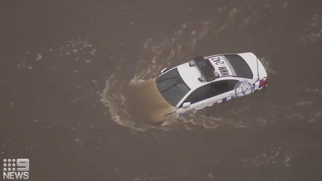 A police car istrapped in the flooded Hawkesbury River on Sunday. Source: Nine News via Twitter