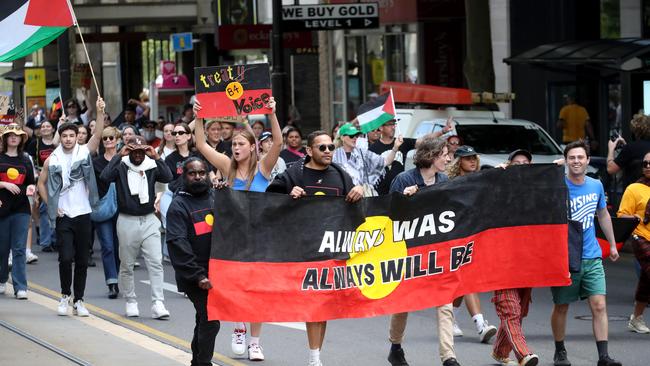 Protesters march down King William St during Adelaide’s Survival Day rally. Picture: Kelly Barnes