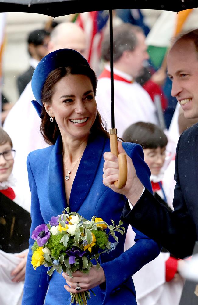 William holds an umbrella while his wife presses the flesh. Picture: Chris Jackson/Getty