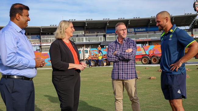 People, Sport and Culture minister Jinson Charls, Major Events minister Marie-Clare Boothby, NT Cricket CEO Gavin Dovey and Jake Weatherald as TIO Stadium's drop-in pitch is laid down.