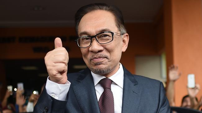 Anwar Ibrahim greets supporters after his release in Kuala Lumpur yesterday, ending years of persecution. Picture: AFP